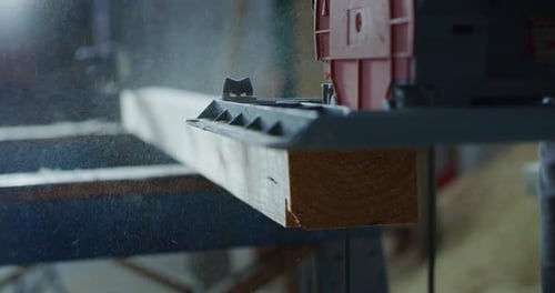 Macro close up of professional carpenter working on woodworking machines in a workshop of wood fac