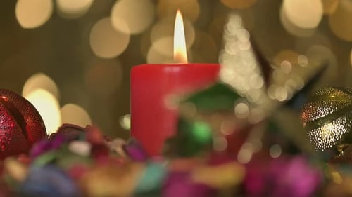 Christmas Candle Burning with Holiday Decorations