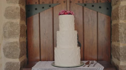 Elegant Wedding Cake Displayed with Roses and Buttercream