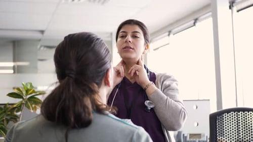 Doctor Explaining Lymph Nodes to Patient in Clinic Adult