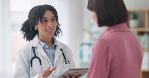 Doctor Using Tablet to Explain Diagnosis to Patient