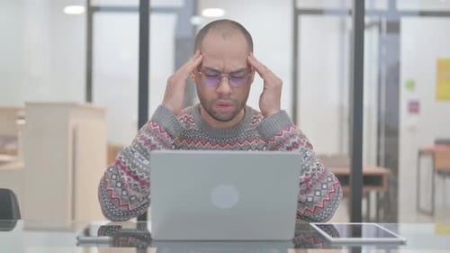 Man With Headache at Office Desk