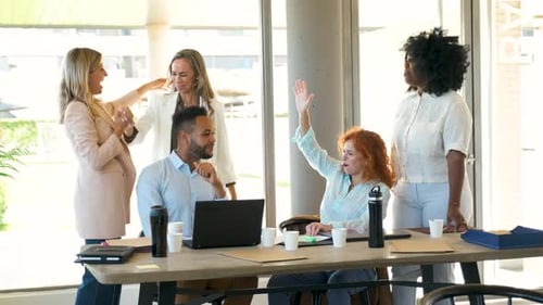 Business People High Five Celebrating Success in an Office
