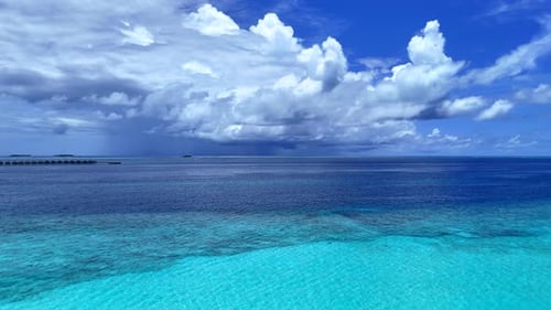 Very beautiful clouds over the water and coral island