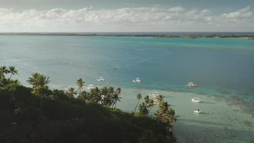 Boats Sailing on Turquoise Water Near Tropical Island Coastline