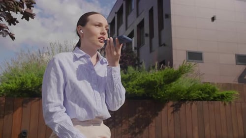 Stylish Woman Uses Voice Recording App Outdoors