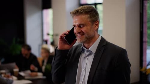 Man Talking on Phone in Office Setting