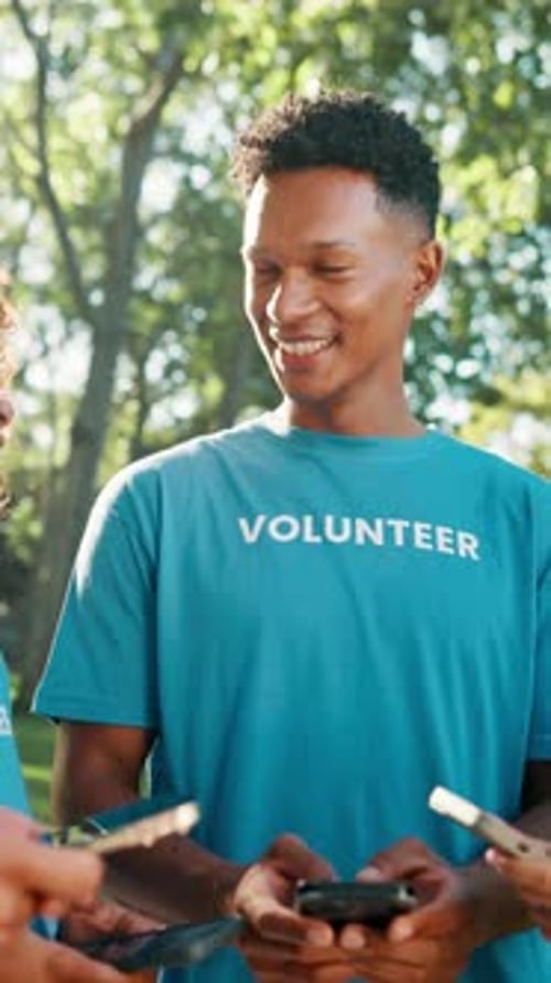 Volunteer group, man or phone at park with laughing, charity event update or funny NGO notification