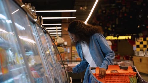 Woman Buying Cheese in Grocery Store