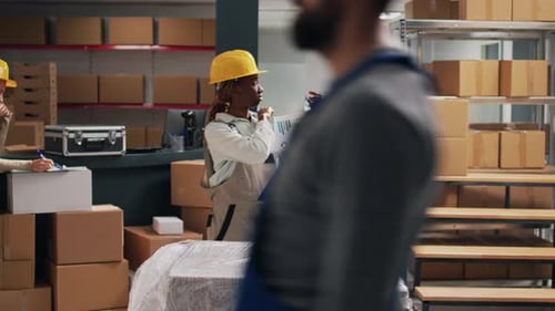 Warehouse Workers Reviewing Inventory in Distribution Center