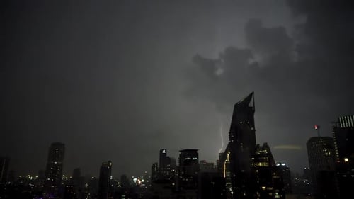 Lightning and rain in modern city center of Bangkok.
