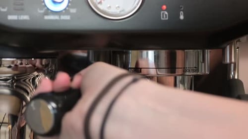 Portafilter Inserted into Stainless Steel Espresso Machine