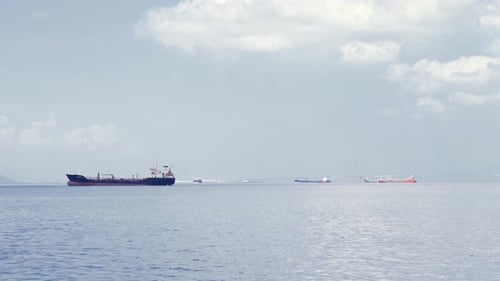 Cargo Ships on the Open Ocean on Cloudy Day