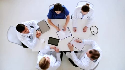 Medical Professionals Collaborate at Table from Above