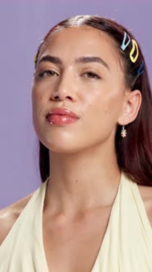 Face, spray and woman in studio, scent and smile with beauty on purple background