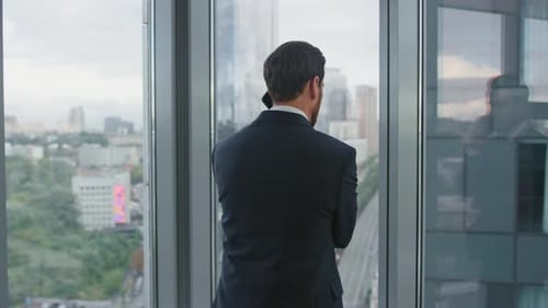 Worried Man Finish Call Standing Near Office Window Closeup. Thoughtful Businessman Feeling Stres...