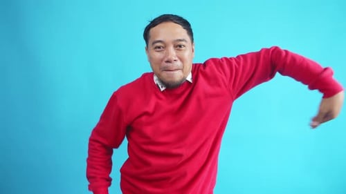 Man Dancing Happily in a Red Sweater