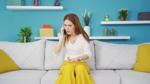 Young woman talking on the phone arguing.