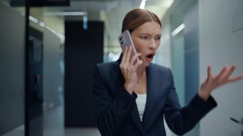Frustrated Businesswoman Arguing on Phone in Modern Office