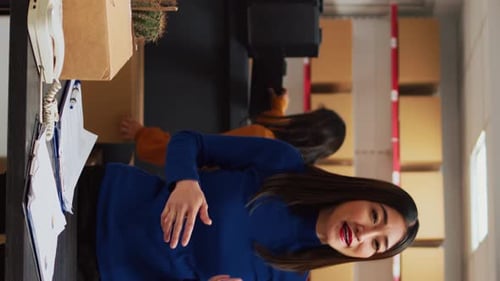Woman Talking in a Shipping Warehouse