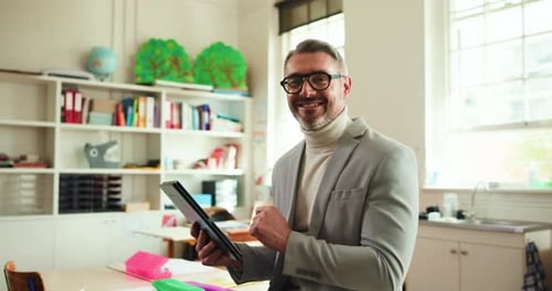 Smiling Teacher Using Tablet in Classroom