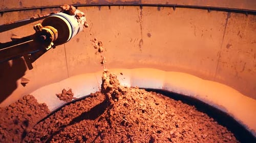 Small clay stones falling into pile
