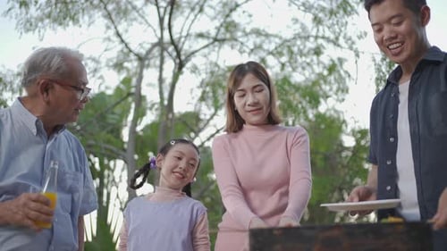 Family Enjoying an Outdoor Barbecue Together