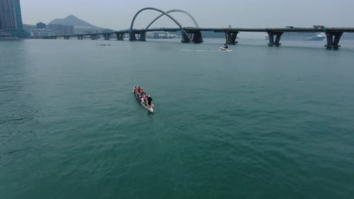 Dragon Boat team rowing to the pace of an onboard Drummer, Aerial view.