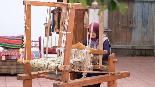 Peasant Woman Weaving A Rug In A Village House