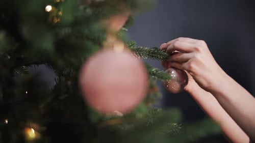 Christmas tree decoration, hands close-up