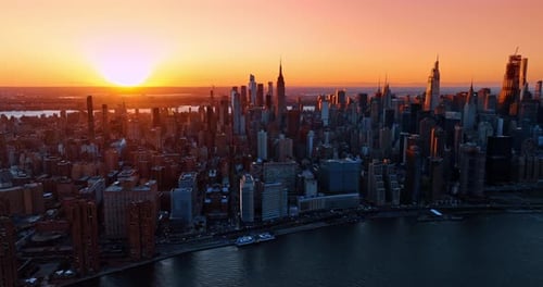 Amazing sunset in the modern metropolis. Panorama of New York, the USA at golden hour time.