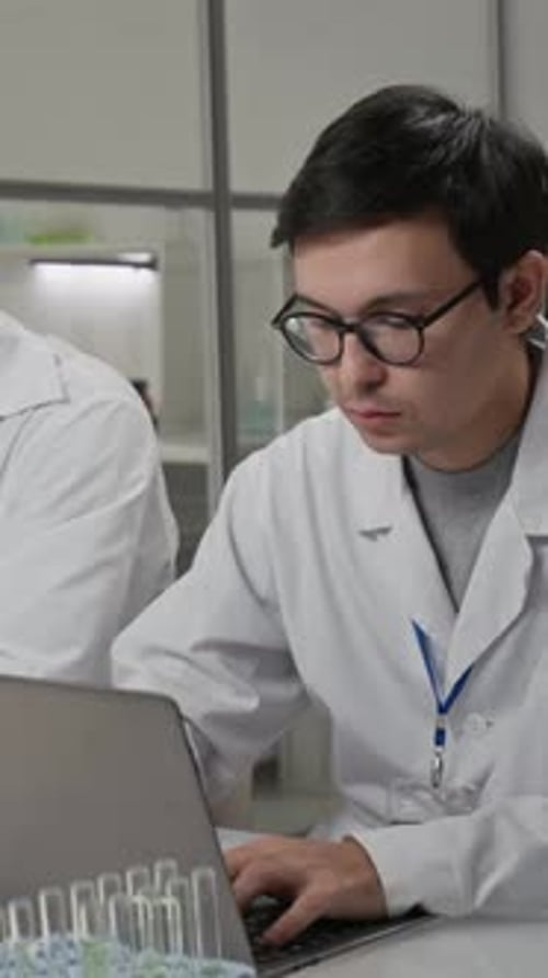 Scientists Working Together in a Lab with Microscope