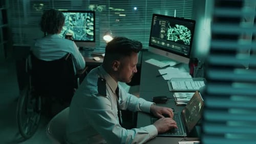 Diverse Military Officers Working on Computers at Command Headquarters