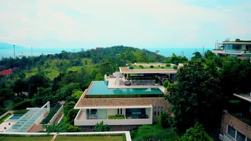 Villas on green mountain ridge. Majestic drone view of luxury villas located on green mountain range