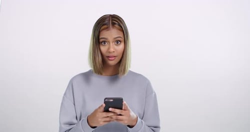 Woman Reacts to Shocking News on Smartphone