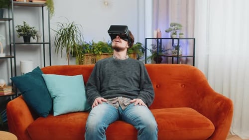 Man Using Virtual Reality Headset on Couch