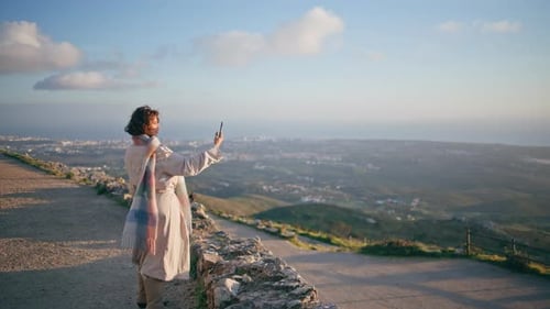 Woman Taking Pictures of Landscape View with Phone