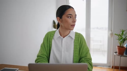 Young Woman Works on Laptop at Home