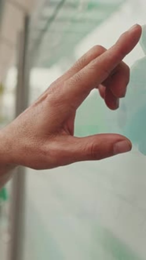 Close-up of unrecognizable man's hand pointing with finger searching public transport traffic