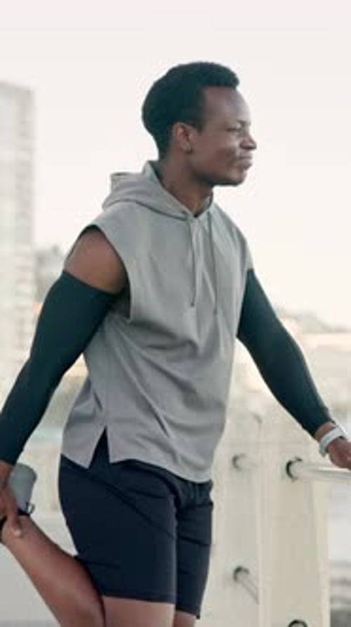 Stretching, fitness and black man on promenade for running, workout or wellness training