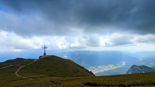 Caraiman Cross on Bucegi plateau with panoramic valley view.