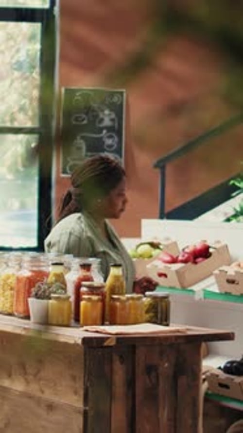 Woman Inspecting Jars of Food in Organic Store