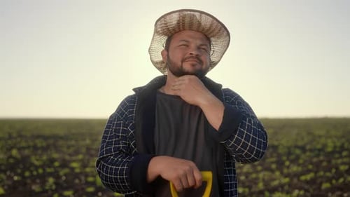 Portrait of Joyful Farm Worker with Straw Hat on Head in Agricultural Fields Smiling Caucasian