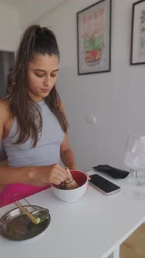 Woman Skillfully Preparing Matcha Green Tea in a Beautifully Modern and Elegant Kitchen