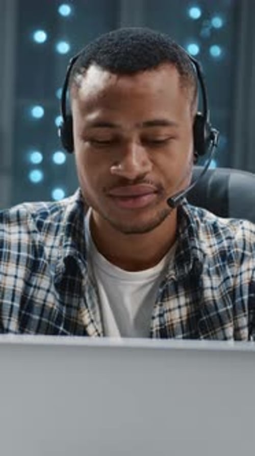 Handsome African Office Manager Wearing Headset Listening to Music Enjoying Sound Rhythm While