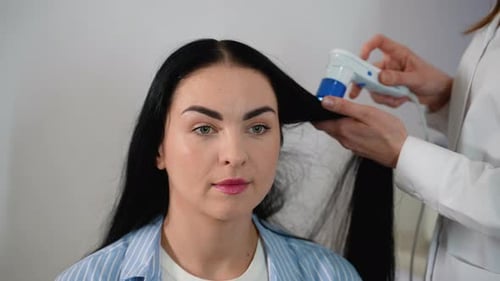 Woman Getting Hair Examined by Professional