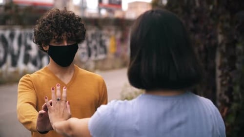 Two Friends Perform a Socially Distant High Five