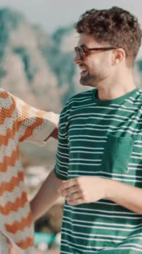 Two Young Men Smiling and Talking Outside