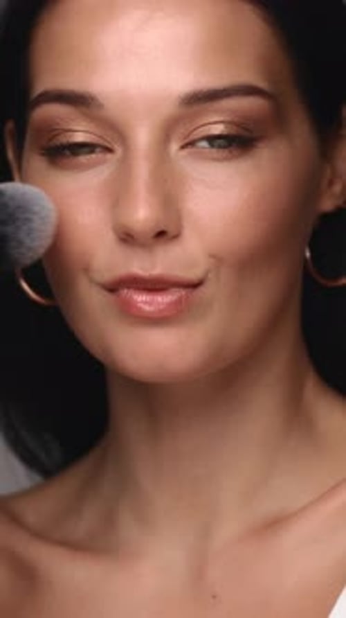 Woman Applying Makeup with Brush, Portrait