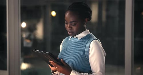 Night, business and black woman with tablet in office, reading feedback or edit investment proposal